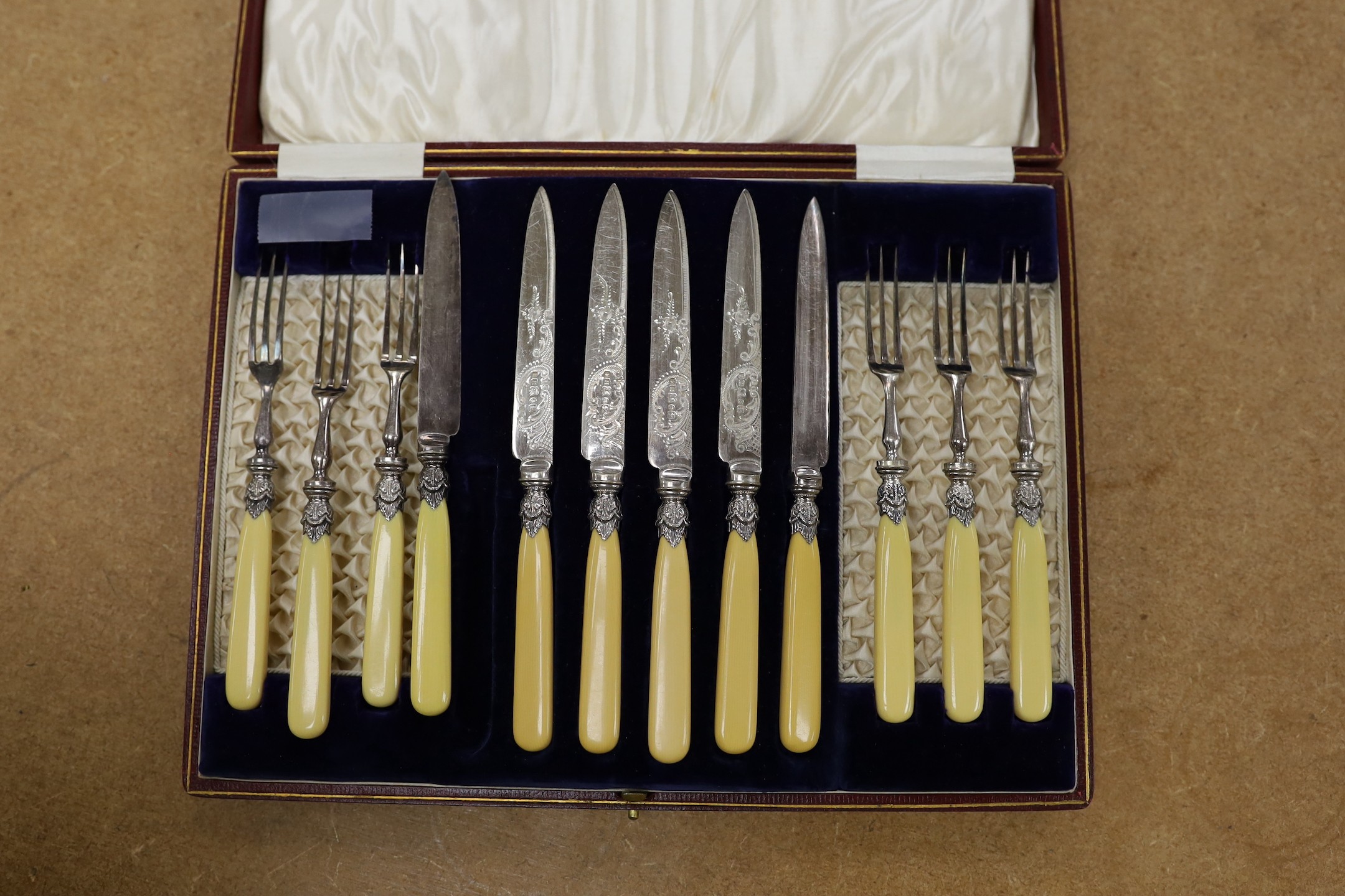 A cased set of six pairs of ivorine handled plated dessert eaters